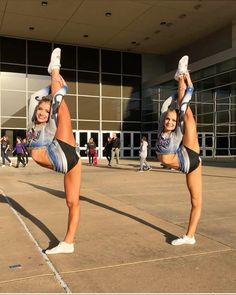 two cheerleaders doing tricks in front of a building