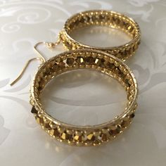 Ribbon Hoop Earrings New beaded earring style at WorkofHeart. Stunning gold beaded earrings. Big bold bright gold hoop earrings made with gold seed beads and good metallic crystal beads. If you love to receive compliments on your jewelry, just wait until you wear these These are possibly the most beautiful pair or earrings in my shop. Each bead is individually and expertly woven to make these beautiful earrings. The french hook earwires are 14kt gold filled. These luxurious earrings measure 2 in Seed Bead Hoop Earrings, Gold Beaded Earrings, Luxurious Earrings, Bead Hoop Earrings, Gold Bead Earrings, Abalone Earrings, Beaded Earring, Earrings Big, Dangle Hoop Earrings