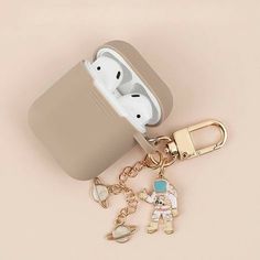 an apple airpods case sitting on top of a keychain