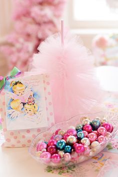 there is a bowl of candy on the table next to a card and some cards