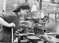 an old photo of a woman working in a factory