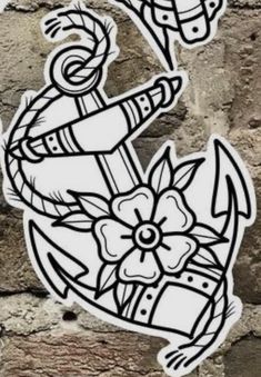 an anchor and flower sticker on a brick wall