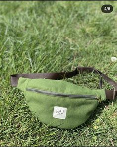 a green fanny bag sitting in the grass