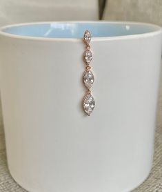 "This top-down belly button ring is the perfect amount of simple and beautiful. Made with surgical steel, this belly button ring dangles with four cubic zirconia marquise crystals, giving it a gorgeous sparkle, and making it practical for everyday wear. Drop jaws with this body jewelry. Silver Version: https://www.etsy.com/listing/959071198/marquise-crystal-silver-top-down-belly?ref=shop_home_active_2&frs=1&crt=1 Details & Size: ♥ Surgical Steel ♥ Cubic Zirconia Gems ♥ Nickel Free ♥ Top Down Belly Ring, Dangle Belly Rings For Wedding, Elegant Dangle Belly Rings For Wedding, Elegant Wedding Dangle Belly Rings, Floating Navel Piercing, Belly Button Rings Dangle, Rose Gold Top, Ring Marquise, Belly Jewelry