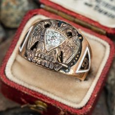 This great vintage mens 32° Masons ring features a diamond at the center of a white gold double eagle. The shoulders and shank of the ring are decorated with enameled masonic symbols. It is crafted in a patinated 10k yellow gold and is a size 8.5. We are not offering resizing due to the enameling. A small amount of enamel shows wear. Formal Symbolic Diamond Ring, Diamond Rings Symbolic For Formal Occasions, Symbolic Diamond Ring For Formal Occasions, Antique Enamel Rings For Formal Occasions, Classic Engraved Enamel Ring For Formal Occasions, Formal Engraved Enamel Signet Ring, Double Eagle, Masonic Symbols, Masonic Ring