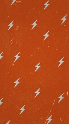 an orange background with white lightning bolts