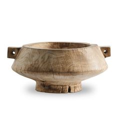 a wooden bowl sitting on top of a white surface