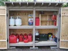 an outdoor storage area with gas cans and other items on it's shelfs