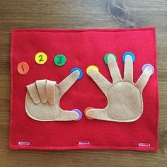 a felt hand and number mat on a wooden table