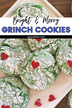 some cookies are on a white plate with red hearts and the words bright & very grinch cookies