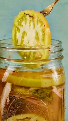 a jar filled with liquid and sliced fruit