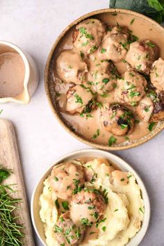 two bowls filled with mashed potatoes covered in gravy