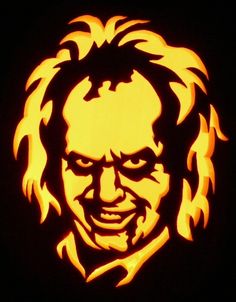 a pumpkin carved to look like an image of a man's face with hair