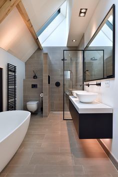 a bathroom with a skylight and two sinks in the center of the bathtub