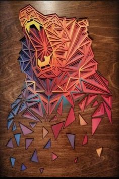 an animal made out of geometric shapes on a wooden surface