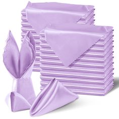 a stack of folded purple napkins next to each other