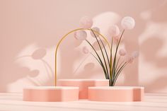 three pink vases with flowers in them on a white countertop next to a light pink wall