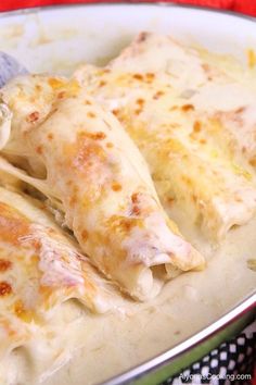 white chicken enchiladas in a green and white bowl