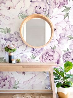 a table with a mirror and flowers on it