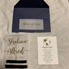 the wedding stationery is laid out on top of the bed with its matching envelope