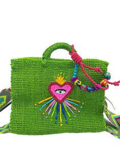 Handmade of henequen and beautifully embellished by artisans in Mexico these bags are a must have for the summer or for a unique gift and special occasion .   Small bag dimensions  Material: Henequen. Height: 9.5 inches Width: 12 inches Depth: 5 inches Medium bag dimensions Material: Henequen. Height: 12 inches Width: 14 inches Depth: 5 inches embroidered straps to be used shoulder or crossbody. variation on color of staps and bag. Picture model is wearing 12 inch Mexican Heart, Bag Picture, Embroidered Handbag, Medium Bag, Embroidered Bag, Beach Bags, Medium Bags, Small Bag, Beach Bag