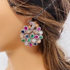 Premium quality American Diamond stud earrings in peacock design with back clip. Multi Color in silver plating  Ruby color in black rose plating  Pastel multi in black Rose plating  Earrings length: 2 inches  Earrings width: 1.10 inches  Care instructions: Avoid Heat and Chemicals like perfume, Deo, Alcohol Etc| clean with Dry Cotton Cloth| Pack in An Air Tight Container After Use. *Disclaimer* ✨ product and color may slightly very due to photographic lighting sources or your screen setting ✨ Yo Multicolor Cubic Zirconia Earrings For Party, Party Multicolor Cubic Zirconia Earrings, Multicolor Cubic Zirconia Party Earrings, Multicolor Cubic Zirconia Crystal Earrings, Multicolor Cubic Zirconia Earrings, Multicolor Cubic Zirconia Earrings For Formal Occasions, Elegant Multicolor Drop Bridal Earrings, Elegant Multicolor Cubic Zirconia Crystal Earrings, Elegant Multicolor Peacock Design Earrings