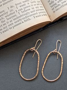 Gold asymmetrical hoop earrings - Gold hoop earrings with gold earhooks. * 14ct Gold Filled (rolled gold- with a brass core) - with gold filled hooks What is 'Gold Filled?'A brass core with a 14ct gold coating. The gold is bonded to the brass core surface using heat and pressure meaning it will never come off, wear away or flake! It is not the same as 'gold plating' but instead is a solid layer of 14ct gold which is approx. 100x thicker than gold plating. Meaning you get the beauty of wearing gold without the hefty price tag! Dimensions-  Hoop size approx 3.7cm by 2.2cm across  Approx 5.2cm total drop. Will arrived gift wrapped in a luxury gift box. With a subtle hammered shimmer that reminds me of the sun glistening of the surface of the sea. Elegant everyday jewellery with a classic time Solid Gold Band, Solid Gold Earrings, Circle Studs, Gold Band Ring, Luxury Gift Box, Simple Jewelry, Everyday Jewelry, Gold Hoop, Gold Earrings Studs