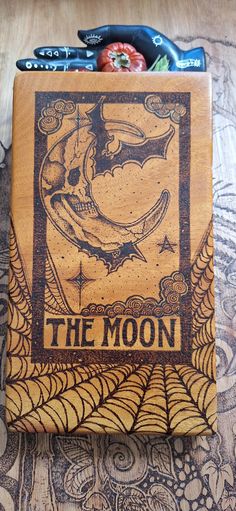 a wooden box with an image of the moon on it