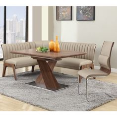 a wooden table sitting on top of a rug next to two chairs and a couch