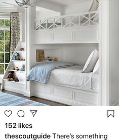 a white bunk bed sitting next to a window