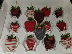 chocolate covered strawberries are arranged in a box