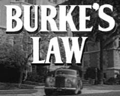 an old car driving down the street in front of a building with words that read, burk's law