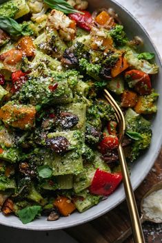 a white bowl filled with broccoli and other vegetables