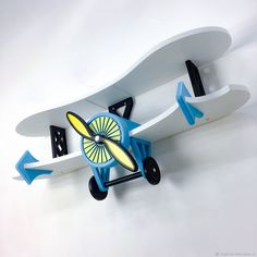 a toy airplane is attached to the wall