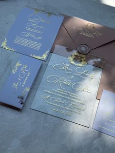 the wedding stationery is laid out on top of the table