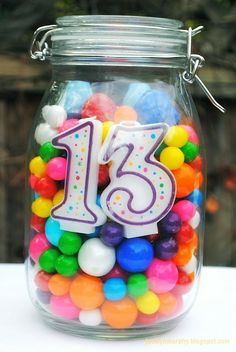 a glass jar filled with lots of colorful candies