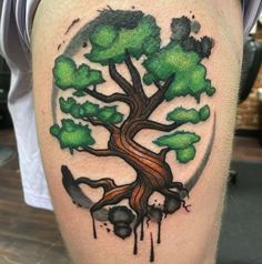 a man with a tree tattoo on his leg