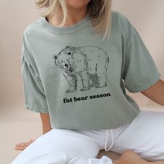 HOLIDAY SHOPPING DEADLINE: Purchase by December 8th to receive your order before December 25th.  This is the perfect shirt to wear while you watch and vote for the fattest bear in the national park! Comfort Colors introduces its garment-dyed t-shirt; a fully customizable tee made 100% with ring-spun cotton. The soft-washed, garment-dyed fabric brings extra coziness to your wardrobe while the relaxed fit makes it an excellent daily choice. The double-needle stitching throughout the tee makes it highly durable while the lack of side-seams helps the shirt retain its tubular shape. .: 100% ring-spun cotton .: Medium fabric (6.1 oz/yd² (206.8 g/m .: Relaxed fit .: Sewn-in twill label Alaskan Wildlife, Camping Tshirt, Comfort Colors Shirt, Dyed Fabric, Cool Tees, Perfect Shirt, Dye T Shirt, Comfort Colors, Alaska