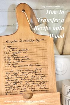 a wooden cutting board with writing on it