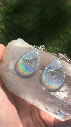 These holographic Teardrop geode earrings made from resin shift from clear to a beautiful sparkly rainbow. They are lightweight and won't bother your ears. Made by Katie Glover Resin Art by Katie 2020 Contact me on my Instagram @123pour if you would like additional photos or videos of this product.Please be aware that this is handmade art and perfection has no place in art. However, this was crafted with love and intention and I hope you are satisfied with your purchase. Your purchase is not ref Silver Resin Drop Earrings, Iridescent Teardrop Hypoallergenic Jewelry, Unique Iridescent Teardrop Earrings, Nickel-free Silver Resin Earrings, Iridescent Resin Drop Earrings, Iridescent Drop Earrings For Gift, Iridescent Dangle Resin Earrings, Iridescent Sparkling Dangle Earrings, Sparkling Iridescent Dangle Earrings