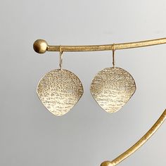 14KT yellow gold matte-finish, textured, round, cobweb/ filigree design circle disc lever back earrings. Nice, size discs that are concave. Measures: 45mm x 28mm Weighs 4.40 grams Stamped 14k Lever back closure Saint Jewelry, Design Circle, Filigree Design, First Contact, Earrings Drop, Matte Gold, 14kt Gold, Other Colors, Dangle Drop Earrings