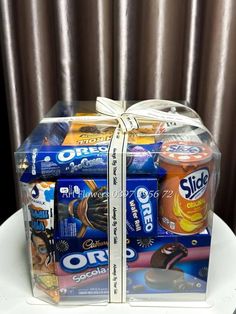 a wrapped gift box filled with snacks on top of a table