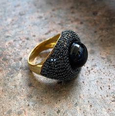 "14k Yellow Gold Sterling Silver Black Onyx Orb Pave Black Spinel Nest Ring Size 6.5 up for offer is a stunning 14k yellow gold over solid sterling silver black onyx orb set in a nest of pave black spinel ring. This ring is marked \"925\". Measurements Ring Size: 6.5 Band Width: 4mm Black Onyx Orb: 13mm Black Spinel: 1.3mm Weight: 9.5 g Materials -14k Yellow Gold -Sterling Silver -Black Onyx -Black Spinel Condition: New; Please look closely at the pictures provided as they are an extension of th Black Ring For Evening Jewelry, Formal Black Sapphire Ring With Accent Stones, Black Gemstone Ring For Anniversary, Black Rings With Gemstone Accents, Black Rings With Gemstone Accents For Gift, Black Jewelry With Gemstone Accents For Gift, Formal Black Jewelry With Gemstone Accents, Formal Black Rings With Accent Stones, Formal Black Onyx Ring