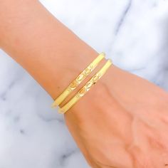 This exquisite pair of 22k gold bangles weighs a total of 26.8 grams and features a reflective triple marquise design that adds a touch of sophistication. The yellow gold finish enhances their elegant appearance, making them a perfect choice for those who appreciate classic beauty with a modern twist. Sized at 2.8 with a 2.5-inch opening diameter, these bangles offer a comfortable fit. Whether worn for special occasions or as a statement piece for daily wear, these bangles are a versatile and stylish addition to any jewelry collection. PRODUCT DETAILS Gold Purity(karat): 22k Gold Weight(grams): 26.8 Item Finish: Yellow Gold Bangle Size: 2.8 Bangle Opening(diameter): 2.5" Number Of Pieces: 2 Bangles Adjustable Yellow Gold 22k Bangle, Elegant Adjustable 22k Gold Bangle, Adjustable 22k Yellow Gold Bangle, Elegant Yellow Gold Plated Bangle, Flexible Yellow Gold Plated Bangle, Gold Flexible Bangle For Wedding, Flexible Yellow Gold Bangle For Wedding, 22k Gold Bangles, Bridal Jewelry Necklace