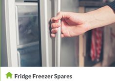 a hand is opening the door to a stainless steel refrigerator