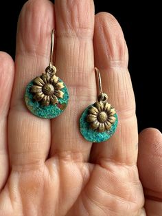 Patina Earrings/ Patina Drop Earrings/Green Patina Earrings/ Daisy Earrings/ Patina Coin Earrings/ Brass Flower Earrings/ Botanical Earrings Patina Daisy Earrings/ Gold Daisy Earrings - Brighten up your day with these playful daisy charm earrings. I developed a rich, verdigris patina then added a hand-finished daisy.  Earrings are sealed and lacquered to preserve the rich color of the patina. Every day wearable botanical earrings! 14K gold-filled French ear wires (shown) or bronze plated copper non-tarnish ear wires. You can select during checkout.  ►To increase the longevity of your purchase, please never let your jewelry get wet or come in contact with chemicals, perfumes, or oily lotions. ►Keep in mind-- Patina has a mind of its own due to the fact that there are multiple variables that Gold Daisy Earrings, Chandelier Jewelry, Patina Earrings, Botanical Earrings, Daisy Charm, Jewelry Making Earrings, Green Patina, Coin Earrings, Daisy Earrings