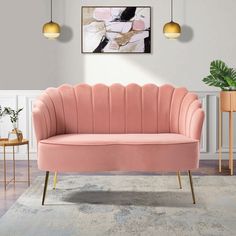 a pink couch sitting on top of a wooden floor