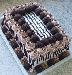 a large cake with chocolate frosting and strawberries on top