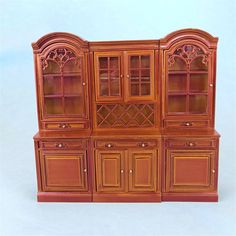 a wooden cabinet with glass doors and drawers on it's sides, in front of a white background