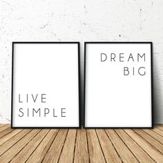 two black and white frames with the words dream big, live simple on them in front of a wooden floor